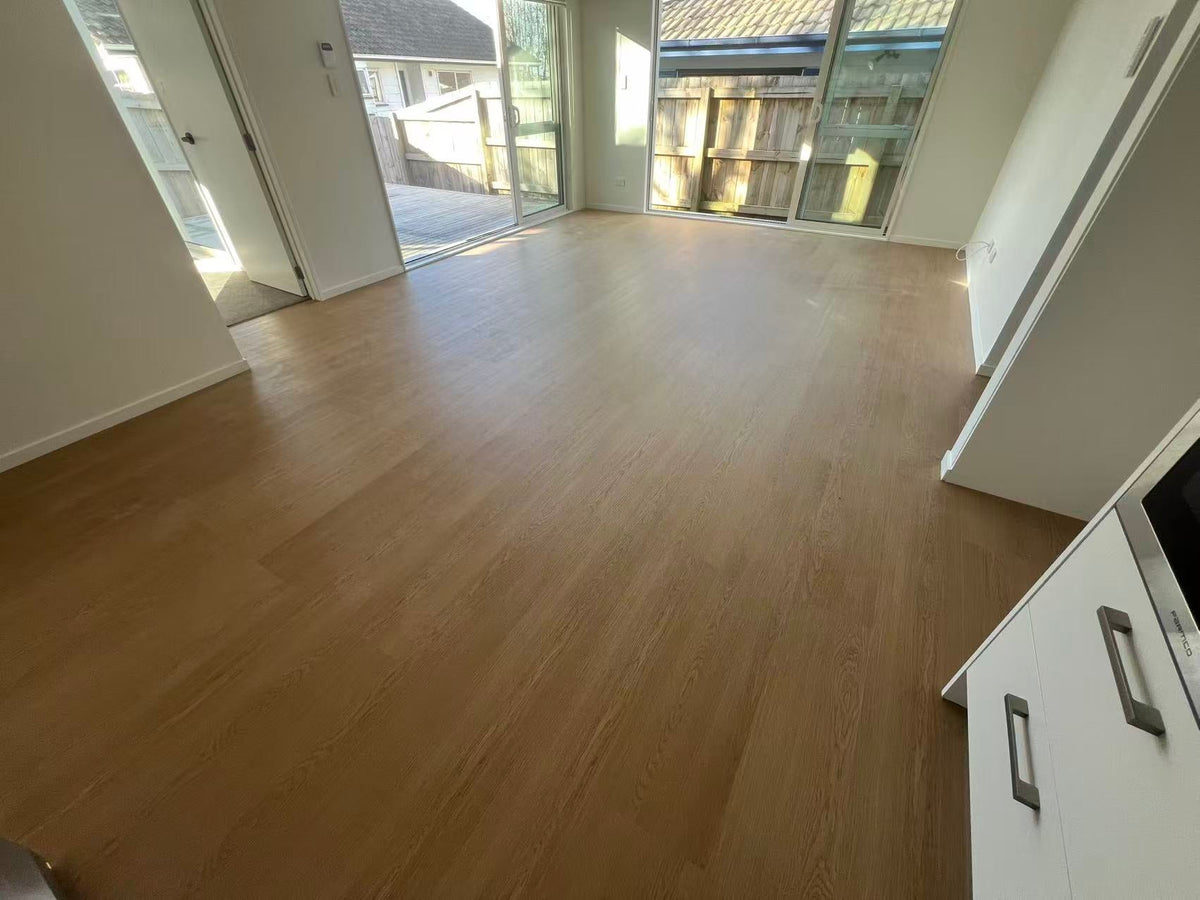 Completed SPC flooring in a Bucklands Beach dining area and hallway by Lee White Flooring